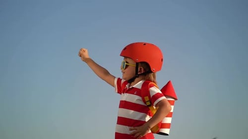 Child Dressed as Rocket Hero Against Blue Sky