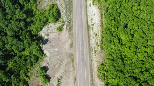 Aerial View Vertically Downward of a White Car Driving on a Country Road
