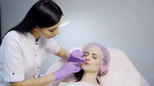 Woman Receiving Cosmetic Injection to Lips