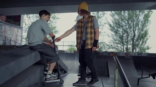 Young Adults Talking at Skate Park on Overcast Day