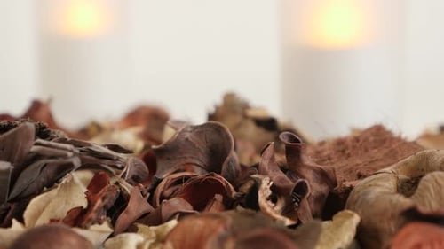 Modern LED candles and potpourri fragrant flowers close-up 4K 2160p 30fps UltraHD tilting footage -