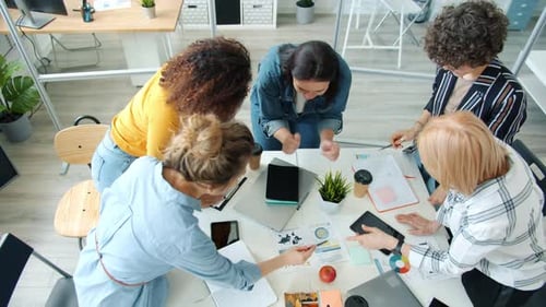 Cheerful and Hardworking Employees Discussing Business Ideas Working in Modern Office