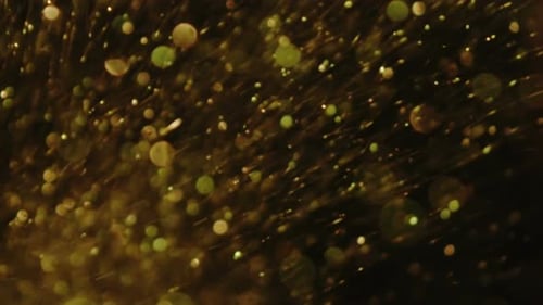 Abstract Gold and Green Bubbles Rising on Black