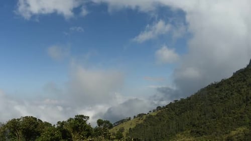 Lush Green Mountain and Cloudy Blue Sky