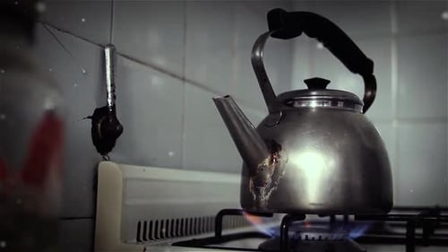 Vintage Teapot Boiling on a Gas Stove