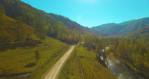 Low Altitude Flight Over Fresh Fast Mountain River with Rocks at Sunny Summer Morning.