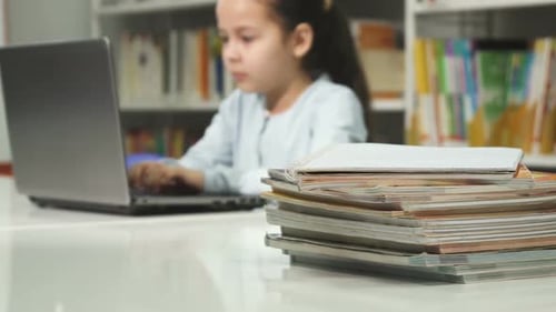 Little Girl Using Laptop at School Studying Doing Homework