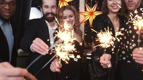 Friends Celebrating Joyfully with Sparklers at Party