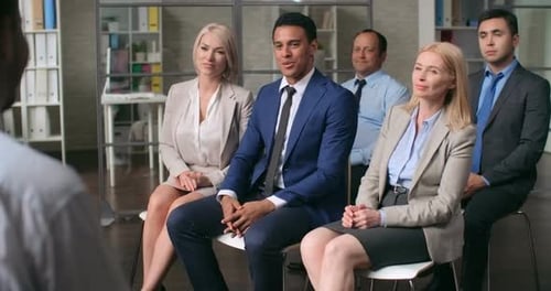 Attentive Business Professionals Applauding a Speaker