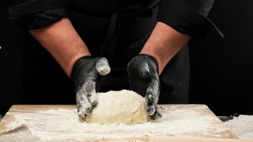 Baker Prepares Dough in Gloves