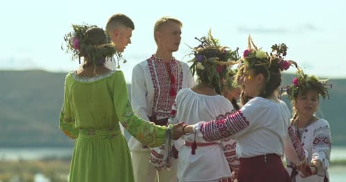 People in Traditional Clothing Holding Hands, Dancing