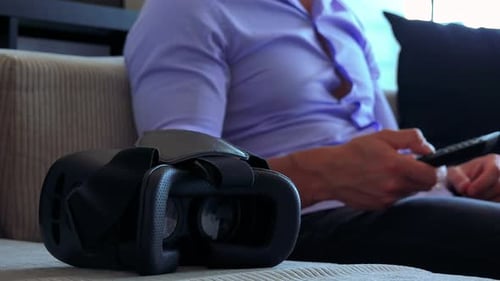 Virtual Reality Headset and a Man on a Couch
