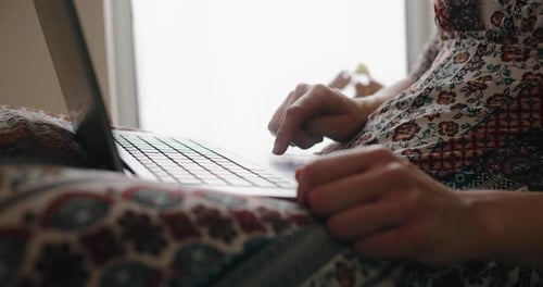 Woman Typing on Laptop Computer Indoors