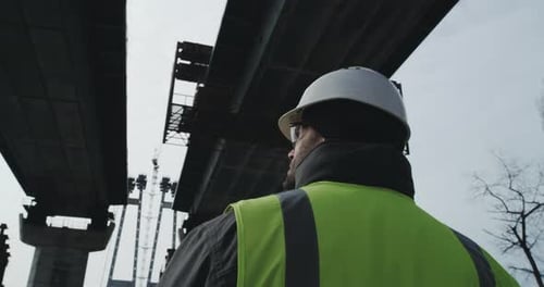 Adult Contractor Inspecting Unfinished Bridge
