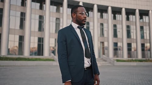 Stylish Professional Businessman Standing By Office Building