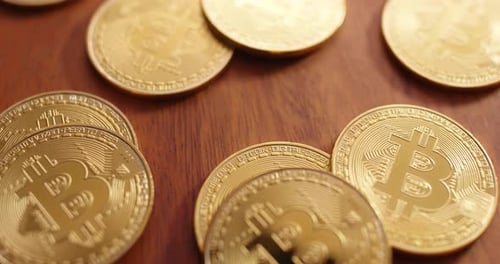 Golden Bitcoin Coins on Wood Table Close Up