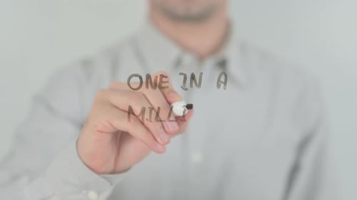 Hand Writes One in a Million on Glass