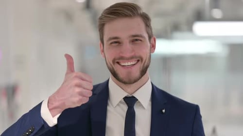 Young Man Smiling and Giving Thumbs Up