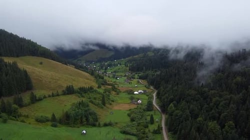 Aerial View Of Village In Mountain Valley With Fog