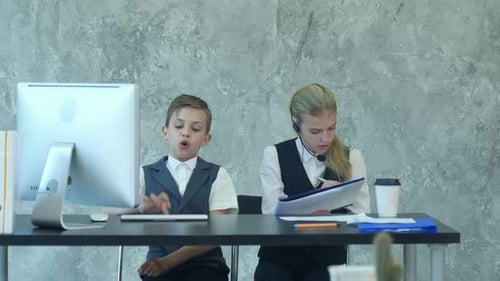 Little Boy and Cute Girl in Business Suits Working in the Office Together