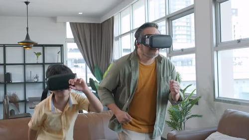 Father and Son Experiencing Virtual Reality in Home