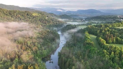 Flying over a river in mist on a beautiful sunrise