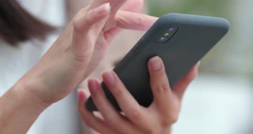 Hands Swiping on Cell Phone Touchscreen Device