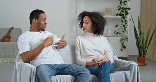 Young Couple Relaxing and Talking on Couch
