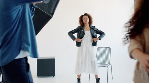 Backstage of Model and Photographer Working in Studio Photographing Posing