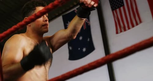 Shirtless Man Boxing in a Boxing Ring