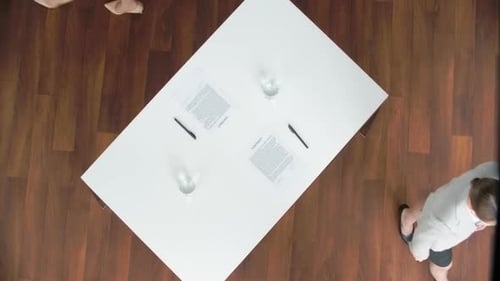 Business People Handshake Over Contract at Table