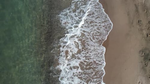 Gentle Waves on Sandy Beach from Above