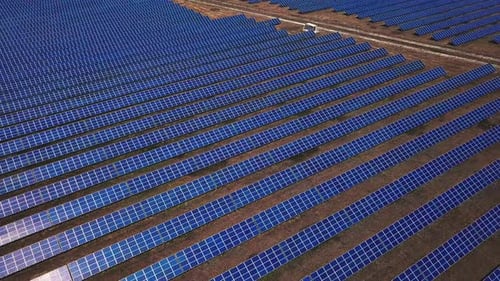 Large Field Of Blue Photovoltaic Solar Panels. Aerial View. Flying Sideways To The Right.
