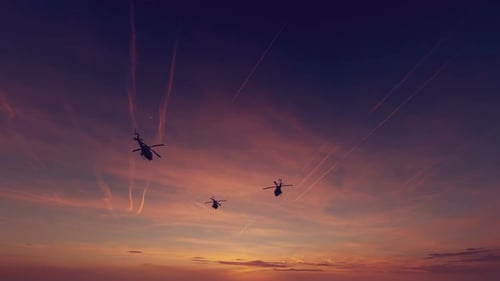 Military Helicopters Silhouette Flying at Dramatic Sunset