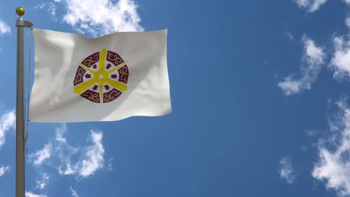 White Flag with Symbolic Wheel Waving Against Blue Sky