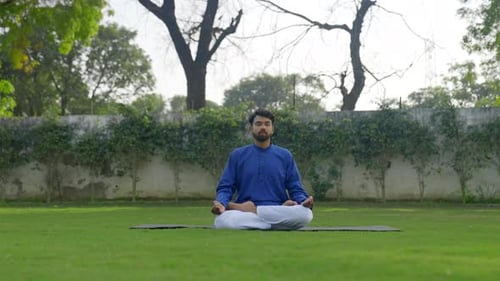 Bearded Man Meditates in a Peaceful Garden