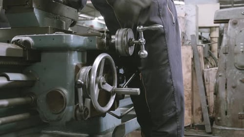 Hand of engineer man operating using industrial machine in factory.