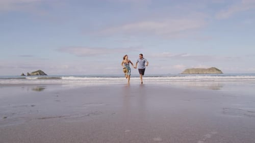 Couple running on beach, slow motion, Costa Rica. Shot on RED EPIC for high quality 4K, UHD, Ultra H