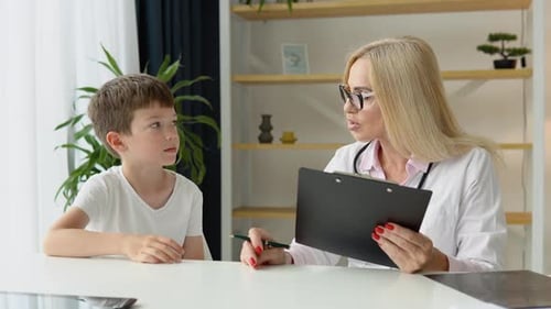 Child Talking With Doctor During Medical Checkup