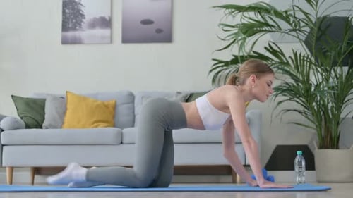 Woman Doing Yoga Exercise on Yoga Mat