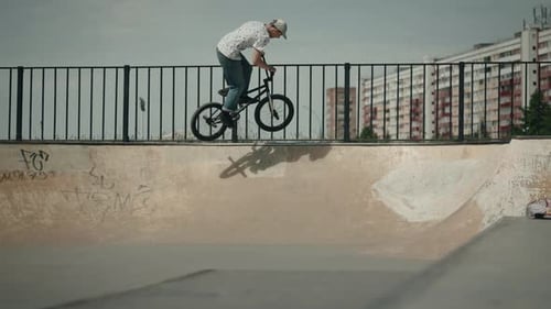 BMX Rider Does Trick in Skatepark