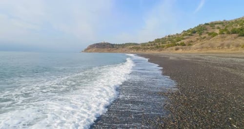 Flying Low Angle Over Splashing Sea Waves Near Coastline