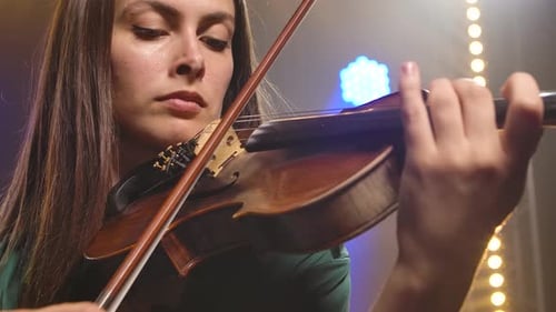 A Virtuoso Violin Performed By a Young Woman. Hands of a Female Violinist Close Up. Slow Motion.
