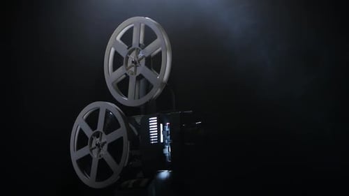 Old Film Projector with Rotating Reels in Smoky Dark