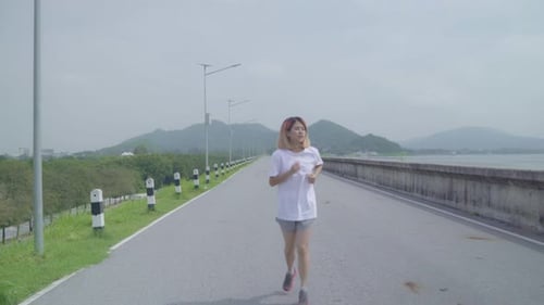 Asian runner woman run and jog on street, Healthy handsome young sporty male exercise near lake.