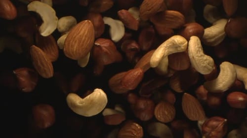 Nuts Are Tossed In The Air In Slow Motion