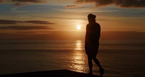 Person Silhouette at Seaside Cliff During Sunrise