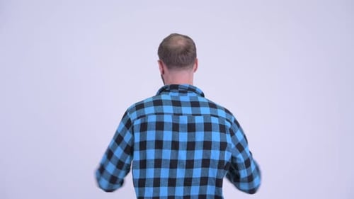 Rear View of Happy Hipster Man with Fists Raised