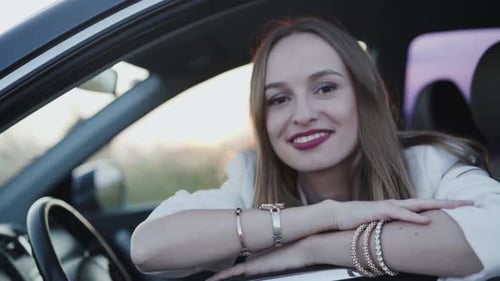 Smiling Woman Leans Out Car Window