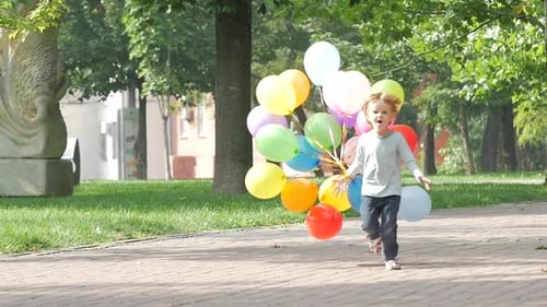 Child Runs with Colorful Balloons in City Park
